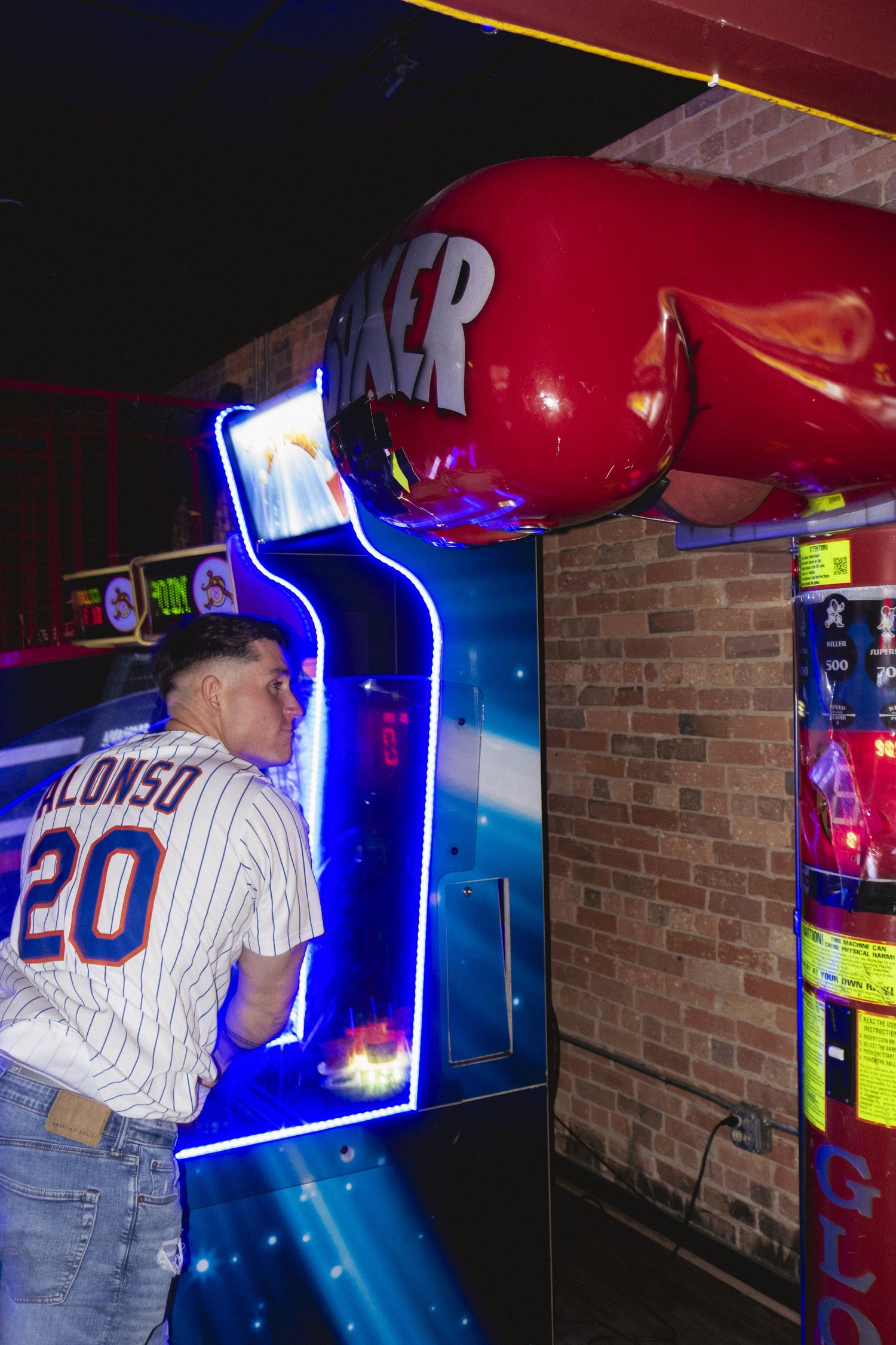 Vintage arcade cabinet lit up at Play Pensacola