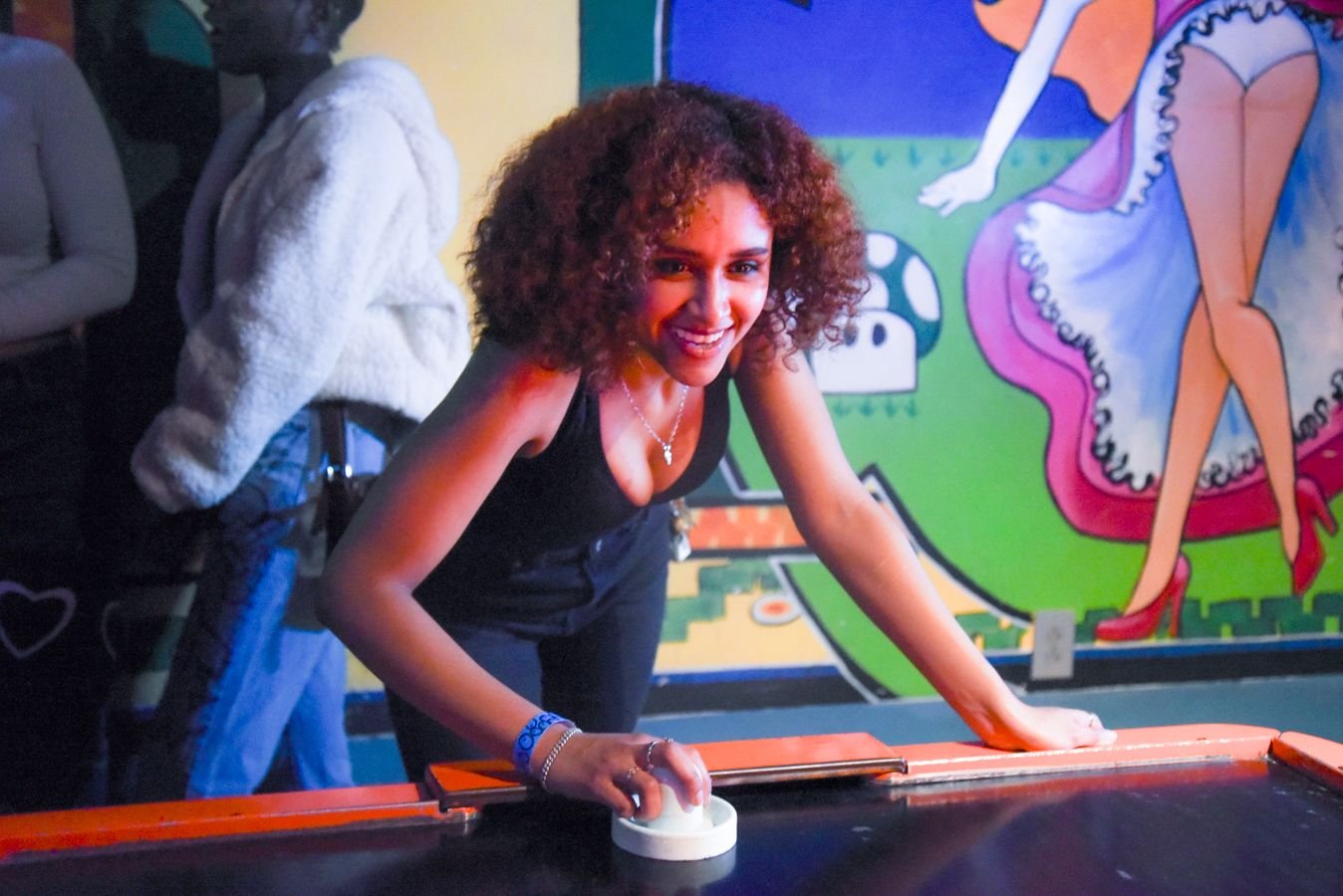 Guests playing pop-a-shot basketball
