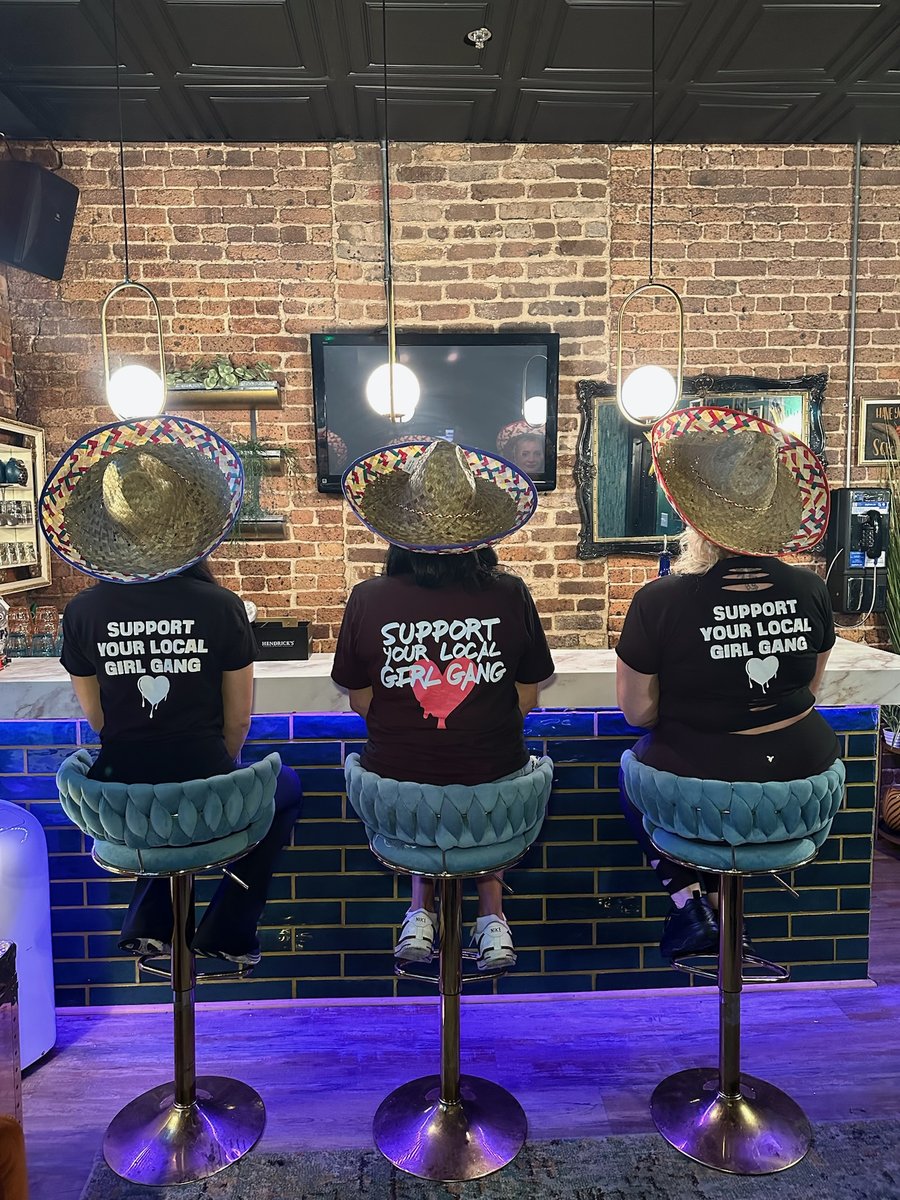 Three Play Pensacola staffers in Support Your Local Girl Gang tees at the bar